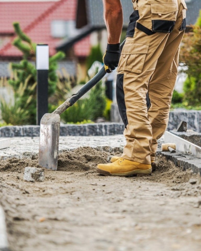 Contractor Laying A Brick Paving Path