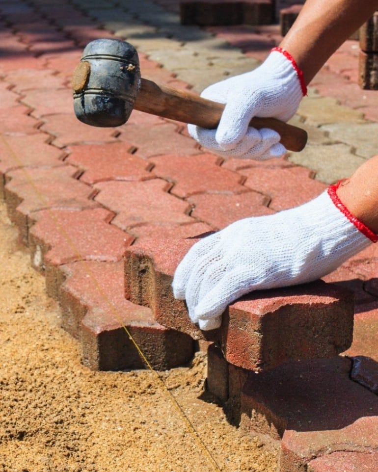 Worker Laying Red Concrete Paving Blocks